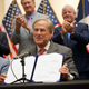 Texas Gov Greg Abbott shows off Senate Bill 1, also known as the election integrity bill, after he signed it into law in Tyler, Texas, Tuesday, Sept. 7, 2021. The sweeping bill signed Tuesday by the two-term Republican governor further tightens Texas’ strict voting laws.